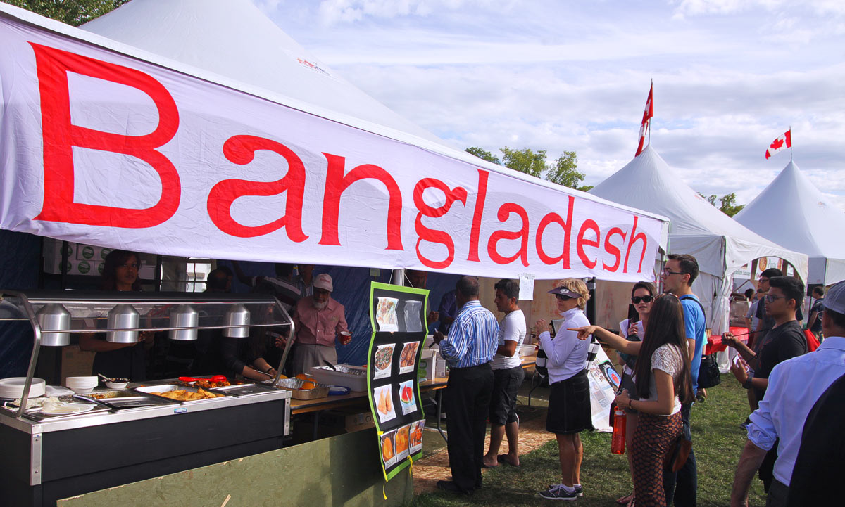 Visitors taste ethnic foods from Bangladesh at the Heritage Festival in Edmonton