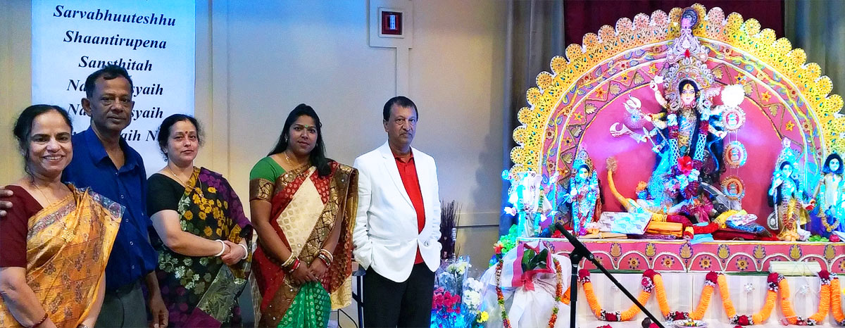 Festival visitors standing beside the 'Puja Mandap'